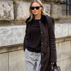 Woman in brown coat and sweater