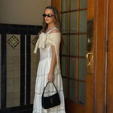 white dress with cardigan over the shoulder