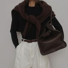 Woman in sweaters with oversize bag